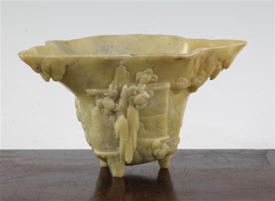 A Chinese pale green soapstone libation cup, 19th century, width 18.5cm, height 10cm, faults